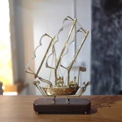 Brass crafted model of sailing ship with wooden base a showpiece for the showcase of livingroom